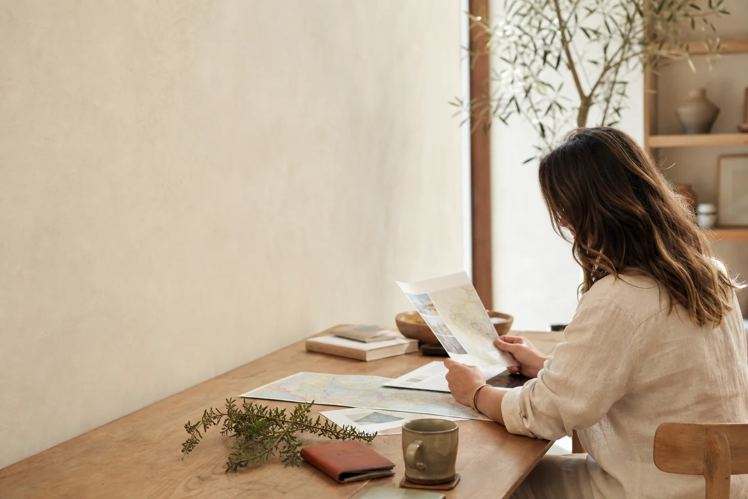 Travel advisor reviewing a map and itinerary in a calm studio